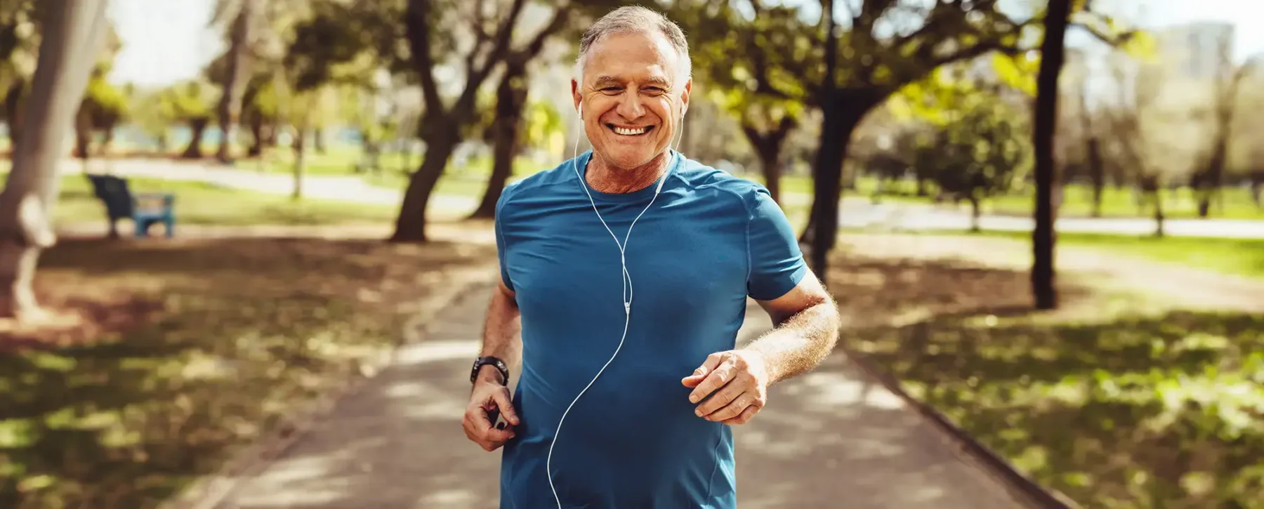 Older man jogging with headphones in