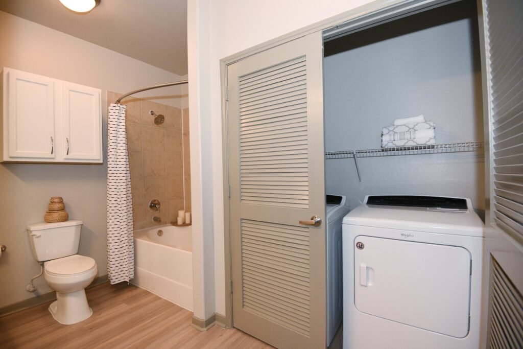 Bathroom with utility closet with washer and dryer